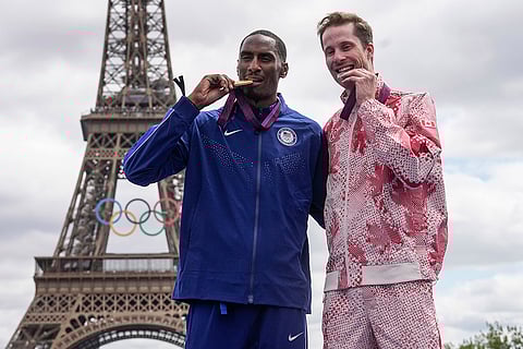 2012 London Olympic men's high jump: Erik Kynard of the United States, left, and Derek Drouin of Canada bite their medals